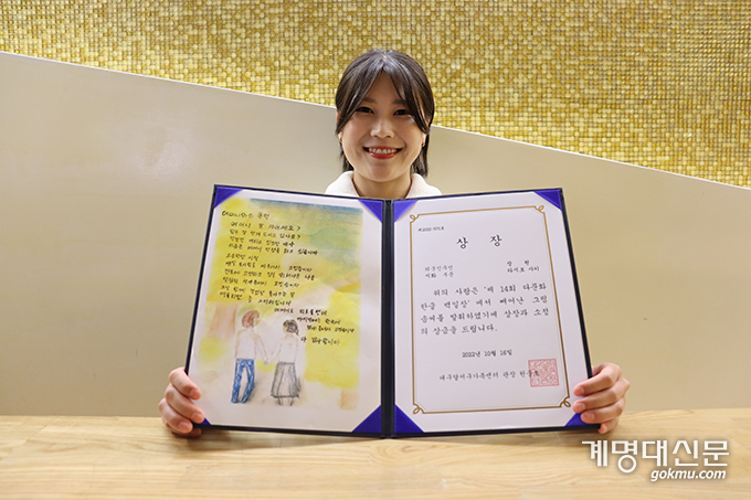 사진: 지난 2022 다문화 한글 백일장에서 시화 부문 장원에 선정된 타시로 사키(영어영문학·2) 씨가 자신의 작품 ‘어머니와 추억’을 들고 있다. ⓒ조형빈 기자
